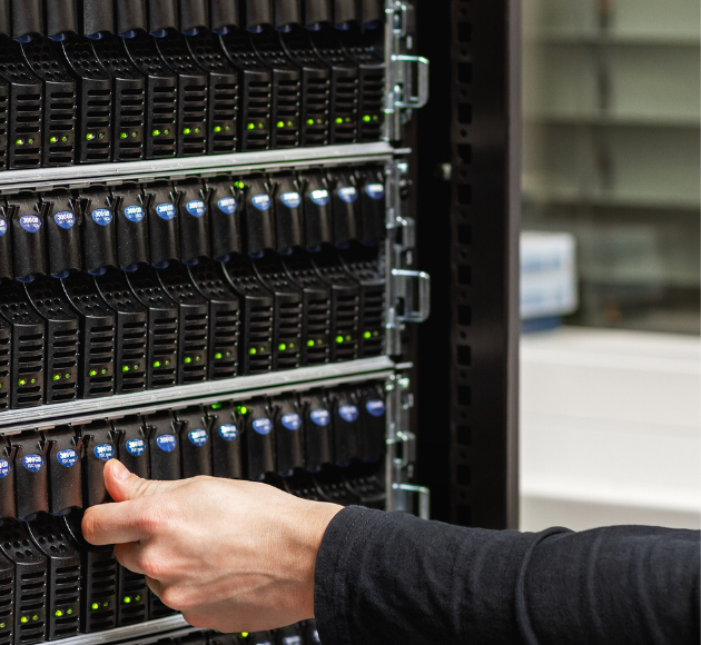Male IT Technician Checking SAN harddrives in Datacenter